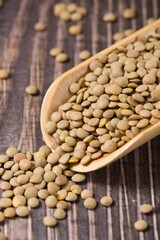 raw lentil culinaris beans on wooden background
