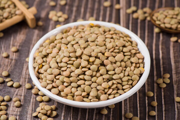 raw lentil culinaris beans on wooden background