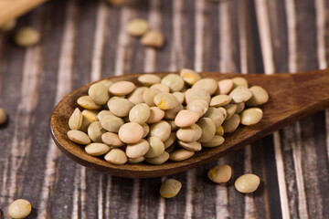raw lentil culinaris beans on wooden background