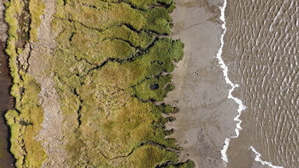 Abstract textures and veins cutting thru the wetlands of a tidal river system in Tasmanias Swan...