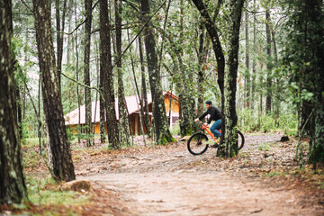 young latin man riding a bike in the mountain on vacation
