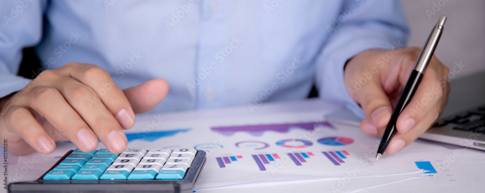 Poster hands of businessman calculate tax with calculator while laptop computer on desk, man planning finan