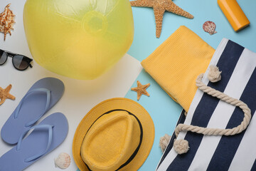 Flat lay composition with beach ball and other accessories on color background