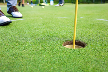 Golf ball on a green grass ready to be struck on golf course background. High quality photo