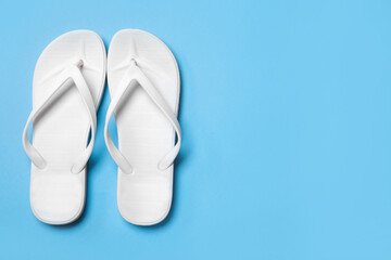 Stylish flip flops on light blue background, flat lay. Space for text