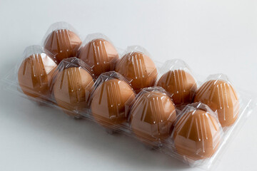 Ten eggs in the egg holder on a white background