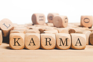 Karma word cube on wood background 