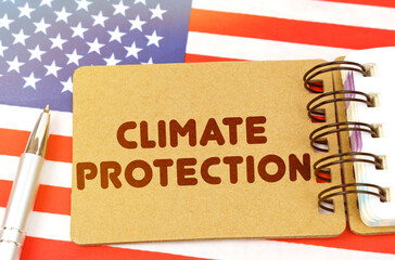 On the US flag lies a notebook with the inscription - Climate protection