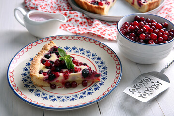 Piece of delicious currant pie served on white wooden table