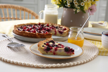 Piece of delicious currant pie on white table indoors