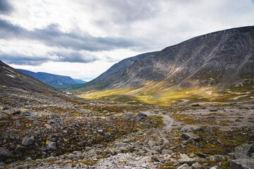 landscape with stones and color moss  the peaks of the Khibiny Mountains on a sunny day. Kola Peninsula, Russia