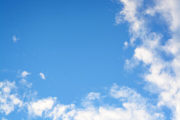 Naklejka na ściany i meble Background with white clouds from the corner edge and blue sky