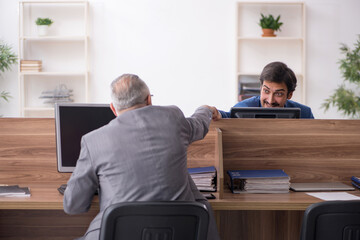 Two male employees working in the office