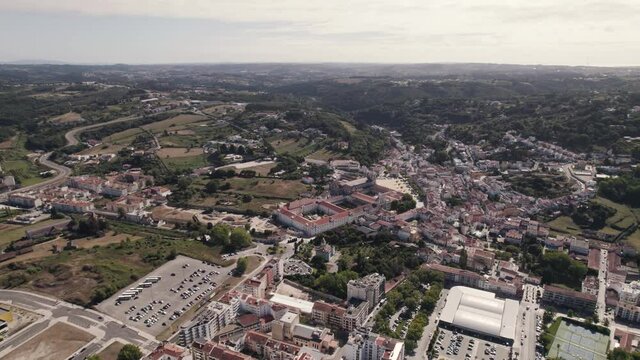 Alcobaça city, aerial establishing shot. Sprawling charming cityscape with famous monastery