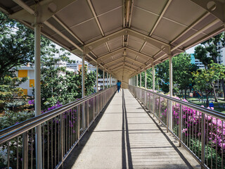 Sheltered walkway of an overhead bridge in a residential neighbourhood of Singapore
