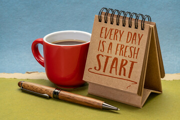 every day is a fresh start inspirational note - handwriting in a desktop calendar with coffee, lifestyle, optimism, positivity and personal development concept