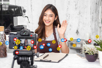 Portrait of happy beauty asian business startup owner barista vlogger woman use camera technology...