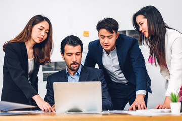 Group of professional success asian business meeting and discussing strategy with new startup project.Creative business people planning and brainstorm with laptop computer in modern office.Teamwork