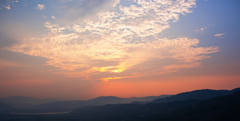 Colorful sunset and sunrise with clouds.Blue and orange color of nature.Many white clouds in the blue sky.The weather is clear today.sunset in the clouds.The sky is twilight.