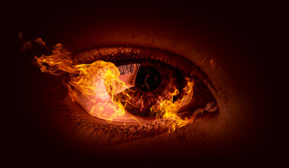 Macro image of human eye with fire flames . Mixed media