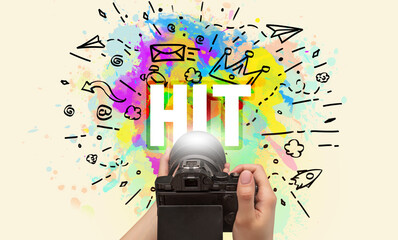 Close-up of a hand holding digital camera with abstract drawing