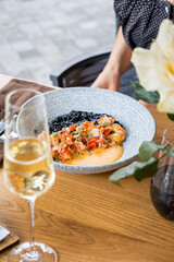 woman eating black rice with shrimps