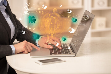 Doctor working on laptop with healthcare concept