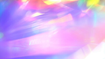 A holographic rainbow unicorn pastel purple pink teal colors abstract background. Optical crystal prism flare beams. Neon light flares