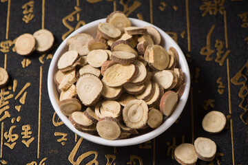 Chinese herbal medicine, sliced of dry Licorice on wooden background