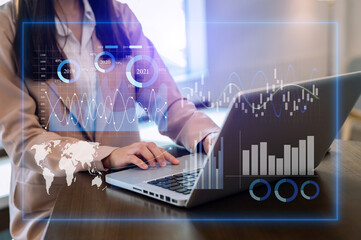 businesswoman using a tablet, smartphone during sunrise overlay with cityscape image. The concept of modern life, business, city life and internet of things