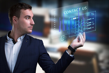 Business, Technology, Internet and network concept. Young businessman working on a virtual screen of the future and sees the inscription: Contact us