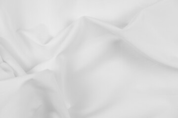 Abstract white fabric texture background. Cloth soft wave. Creases of satin, silk, and cotton.