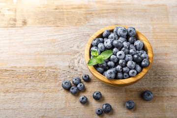 Fototapeta na wymiar Freshly picked blueberries in a wooden bowl. Healthy berry, organic food, antioxidant, vitamin