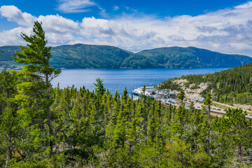 Naklejka premium View on the Saguenay Fjord and Baie Sainte Catherine ferry boat from the top of Anse a l'Eau hill, in Tadoussa, Quebec (Canada)