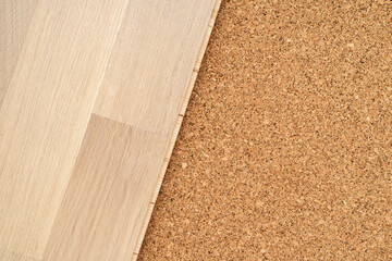 Finishing materials for flooring. Laying parquet boards on natural cork for underlayment.