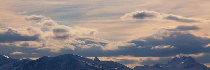 Beautiful landscape of Norway. Colorful sky and mountains in background.