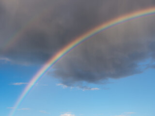 natural phenomenon bright colorful rainbow in the clouds