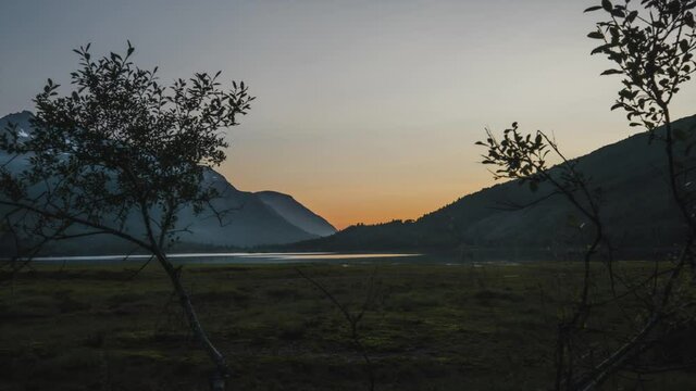 Beautiful Orange Sunset Behind Mountains With Lake At Innerdalen Valley In Norway. - Time Lapse