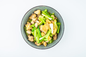 Chicken with celery on a dish on white background