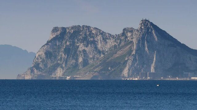 Gibraltar rock with town area at the foot. View from Torrecarbonera beach, Punta Mala, Andalusia Spain. Tourist attraction.