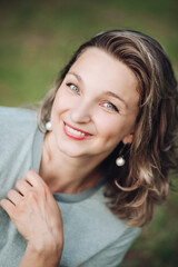 Fototapeta premium Optimistic beautiful woman smiling at camera.Blurred background.