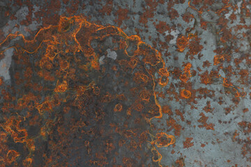 metal surface of gray color with rust in the form of streaks and inclusions, top view