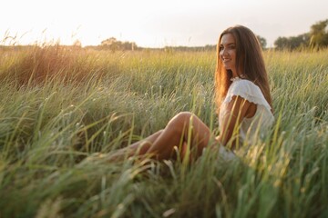 Side view portrait of smiling woman with long hair in summer field  - 455220092