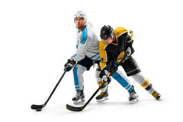 Two professional hockey players on ice. Fight for the puck. Concept of sport, healthy lifestyle, action. Isolated on a white background