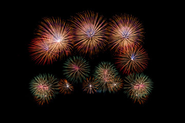 Fireworks of various colors bursting against a black background