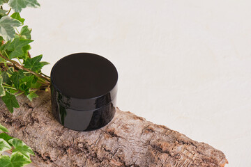 Cosmetic black cream jar Natural cosmetics concept.