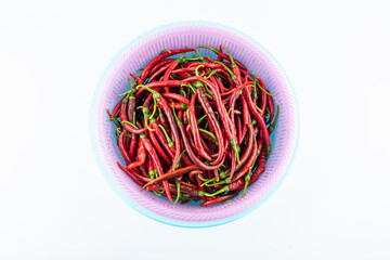 Fresh red peppers in a pot on white background