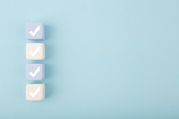 Four checkmarks against bright pastel blue background with copy space. Concept of questionary,...
