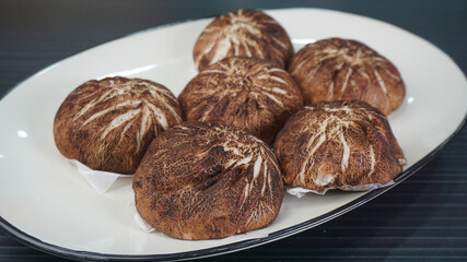Chinese Hong Kong steamed fresh mushroom vegetable cheese lava bun vegan bao zi in leaf shape on...