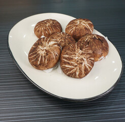 steamed fresh mushroom cheesy bun baozi in mushroom shape on dark grey wood background dim sum halal menu
